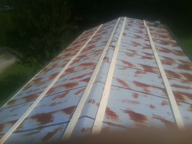 Rusted metal roof panels with new wood purlins before replacement — Storm Damage Roof Repair in Medora by Roofing Brothers