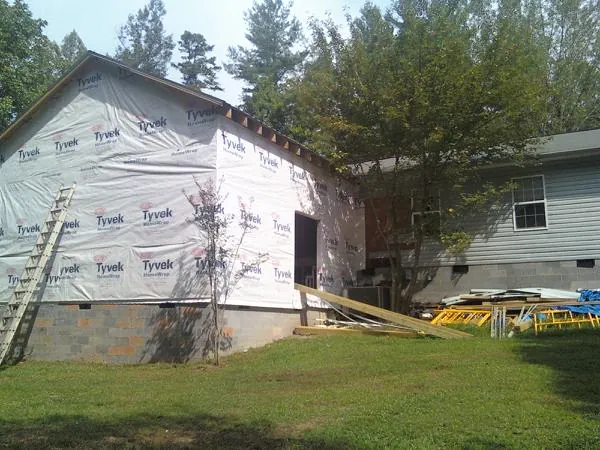 Tyvek wrapped gable on a new room addition beside an existing home in Medora